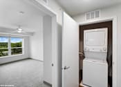 Thumbnail 23 of 40 - A white room with a window and a washing machine.