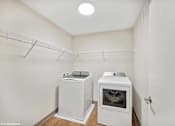 Thumbnail 24 of 40 - A small kitchen with a white oven and a white cabinet.