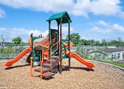 Thumbnail 34 of 40 - A playground with a green roof and orange slides.