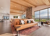 Thumbnail 13 of 30 - A modern living room with a large couch and a view of the mountains.
