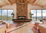Thumbnail 10 of 30 - A modern living room with a stone fireplace and a large window.