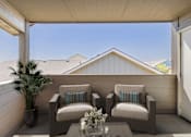 Thumbnail 6 of 28 - a covered patio with two chairs and a palm tree