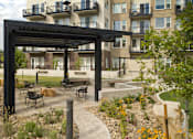 Thumbnail 3 of 67 - an outdoor patio with a fire pit and a building in the background at Cycle Apartments, Fort Collins, Colorado