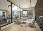 Thumbnail 6 of 26 - a living room with two hanging chairs and a large window