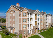 Thumbnail 23 of 26 - A large apartment complex with multiple buildings and balconies.