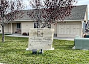 Thumbnail 1 of 4 - A sign for Timberlake Village Apartment Community stands in the grass.