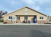 Thumbnail 2 of 4 - A building with a bicycle parked in front of it.