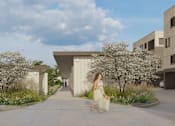 Thumbnail 1 of 10 - A woman in a white dress is walking down a sidewalk in front of a modern building.