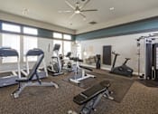 Thumbnail 17 of 37 - A spacious home gym with a variety of exercise equipment.