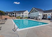 Thumbnail 20 of 37 - A swimming pool in a residential area with houses in the background.