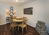 Thumbnail 15 of 37 - A dining room with a wooden table and chairs.