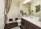 Thumbnail 13 of 37 - A bathroom with a toilet, sink, and shower.