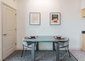 Thumbnail 7 of 29 - A dining room with a glass table and two chairs.