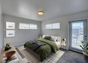 Thumbnail 1 of 41 - A bedroom with a bed, nightstand, and window at Four Points, Montana