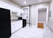 Thumbnail 3 of 27 - Kitchen with Black appliances at Willett Apartments, New York