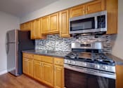 Thumbnail 3 of 23 - Kitchen with wooden cabinets at Garwood Gardens Apartments, New Jersey, 07027