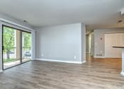Thumbnail 17 of 41 - an empty living room with sliding glass doors to a balcony at Boulder Pointe Apartments in Middletown, NY 10940