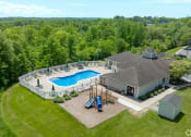 Thumbnail 37 of 41 - aerial view of a pool and a house with a deck and a swimming pool at Boulder Pointe Apartments in Middletown, NY 10940