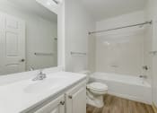 Thumbnail 6 of 41 - a bathroom with a sink toilet and a tub at Boulder Pointe Apartments in Middletown, NY 10940