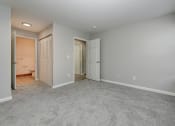 Thumbnail 19 of 41 - bedroom and a door to a bathroom at Boulder Pointe Apartments in Middletown, NY 10940