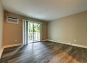 Thumbnail 9 of 17 - A room with a sliding glass door leading to a balcony.