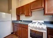 Thumbnail 4 of 22 - A white stove with a white oven in a kitchen.