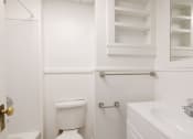 Thumbnail 7 of 23 - a white bathroom with a toilet and a sink