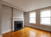 Thumbnail 9 of 23 - the living room of an empty house with a fireplace
