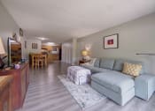 Thumbnail 24 of 45 - Living room and dining room with a couch and a table at Cedar Park Apartments, Troy, NY, New York