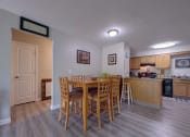 Thumbnail 21 of 45 - Dining area with a table and chairs and a kitchen at Cedar Park Apartments, New York