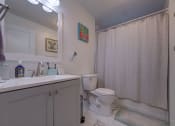 Thumbnail 18 of 45 - Bathroom with a toilet and a sink at Cedar Park Apartments, Troy, New York