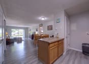 Thumbnail 14 of 45 - Kitchen island and a living room with a dining room at Cedar Park Apartments, Troy, NY