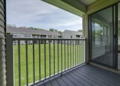 Thumbnail 22 of 47 - a view of a yard from a balcony with a sliding glass door