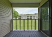Thumbnail 21 of 47 - a balcony with a view of a yard and a house