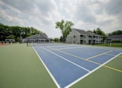 Thumbnail 39 of 55 - A tennis court with a blue and green surface and white lines.
