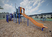 Thumbnail 43 of 55 - A playground with a slide and climbing structure.