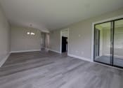 Thumbnail 16 of 47 - a empty living room with a sliding glass door to a balcony