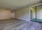 Thumbnail 9 of 34 - A room with a sliding glass door leading to a patio.