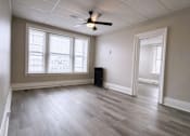 Thumbnail 11 of 27 - Room with ceiling fan and wooden floor at Willett Apartments, Albany, NY, 12210