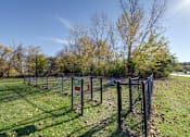 Thumbnail 26 of 30 - A chain link fence surrounds a green field.