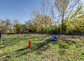 Thumbnail 27 of 30 - A playground with a red fire hydrant and a blue slide.