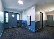 Thumbnail 14 of 23 - A room with a blue door and a window.