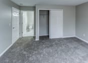 Thumbnail 13 of 33 - an empty room with a closet and a bathroom