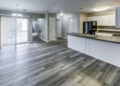 Thumbnail 5 of 33 - a kitchen and living room with wood flooring in an apartment