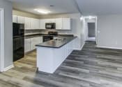 Thumbnail 3 of 33 - a kitchen with white cabinets and a counter top