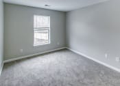 Thumbnail 18 of 33 - an empty room with carpet and a window