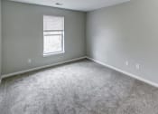Thumbnail 16 of 33 - an empty room with carpet and a window