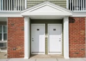 Thumbnail 4 of 30 - a pair of white doors on a red brick building