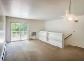 Thumbnail 12 of 30 - a bedroom with white walls and a sliding glass door leading to a balcony