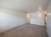 Thumbnail 17 of 30 - a bedroom with white walls and carpet